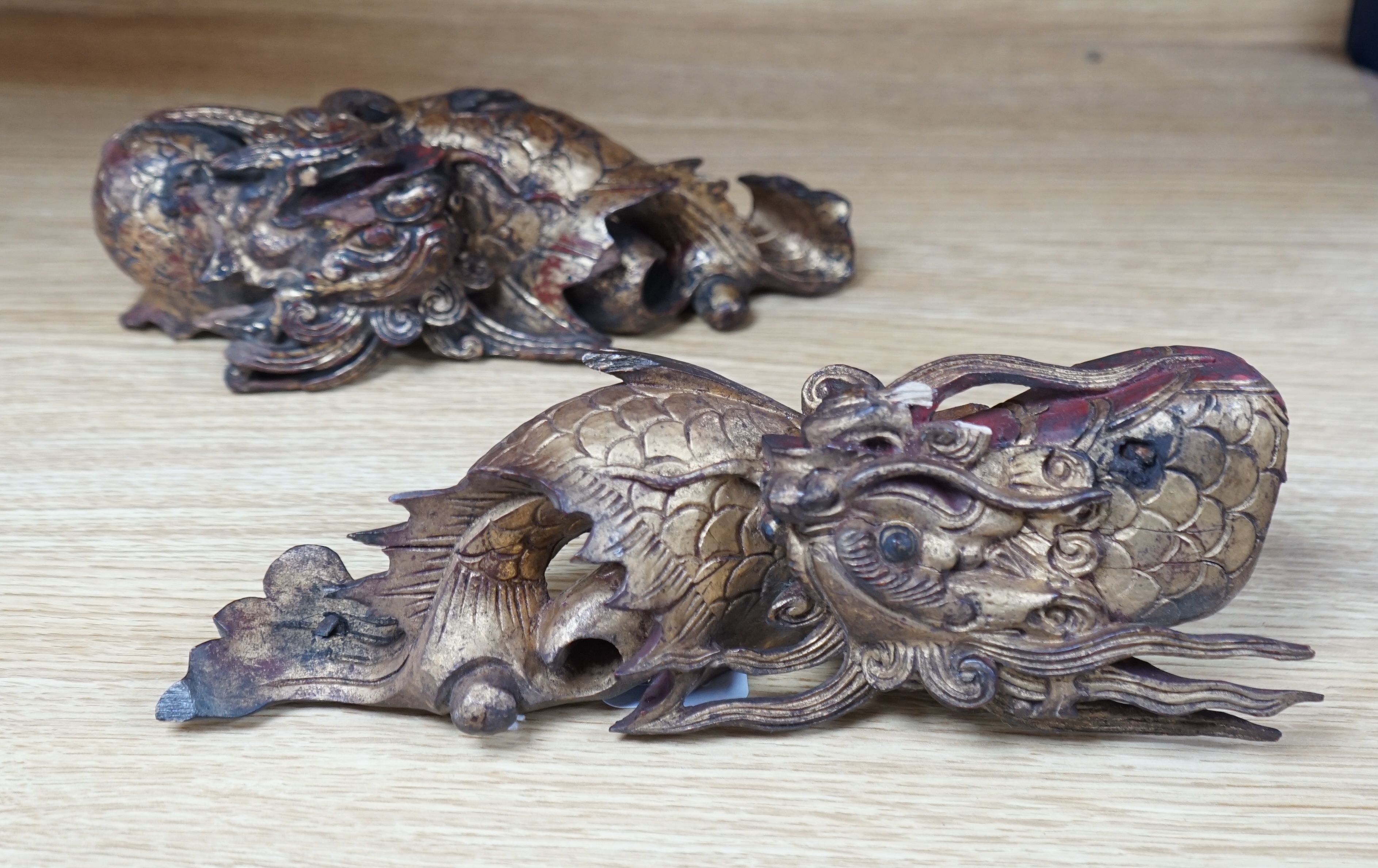 A pair of Chinese giltwood figures of dragons, late 19th century, longest 27cm. Condition - fair